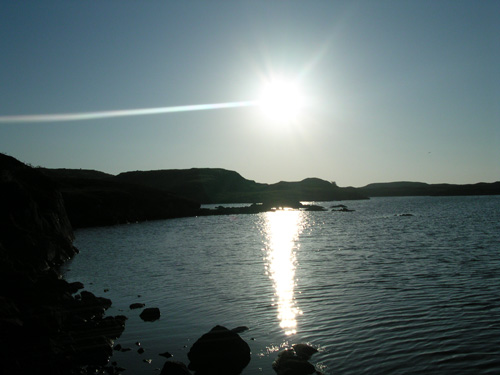 Oban nan Crothintin, a sea loch at Craigstrome. For some reason a plane decided to fly into the sun!