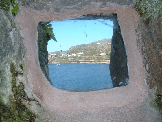 Taken from a peep-hole on Kisimul Castle towards the beautiful Isle of Barra.